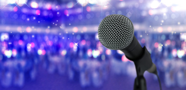 Close up microphone  on stage in concert hall or conference ball room.